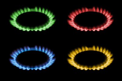 gas burns with red, blue, yellow, green flame on a black background, a collage and three different-colored burning gas.