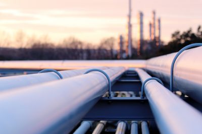 steel long pipes in crude oil factory during sunset steel long pipes in crude oil factory during sunset