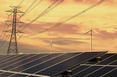 electricity power in nature. clean energy concept. solar panel with turbine and tower hight voltage electricity power in nature. clean energy concept. solar panel with turbine and tower hight voltage