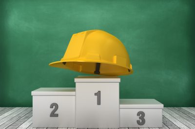 Podium with Construction Helmet on Chalkboard Background – 3D Rendering Podium with Construction Helmet on Chalkboard Background – 3D Rendering