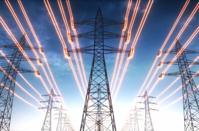 Electricity transmission towers with red glowing wires Electricity transmission towers with red glowing wires