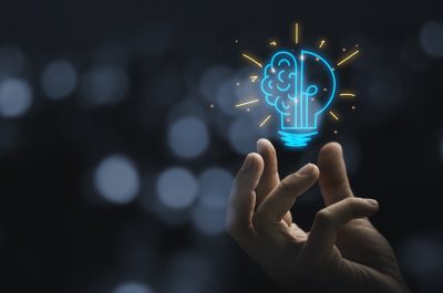 Hand holding drawing virtual lightbulb with brain on bokeh background for creative and smart thinking idea concep Hand holding drawing virtual lightbulb with brain on bokeh background for creative and smart thinking idea concep