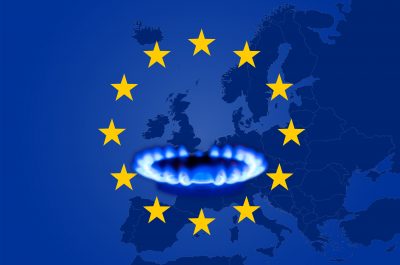 Deficit and gas crisis in Europe. Flag of the European Union with a geographic map and a burning gas stove. Copy space. Deficit and gas crisis in Europe. Flag of the European Union with a geographic map and a burning gas stove. Copy space.