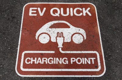 Electric vehicle (EV) quick charging point sign on the asphalt at the charging station point Electric vehicle (EV) quick charging point sign on the asphalt at the charging station point