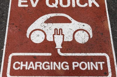 Electric vehicle (EV) quick charging point sign on the asphalt at the charging station point Electric vehicle (EV) quick charging point sign on the asphalt at the charging station point