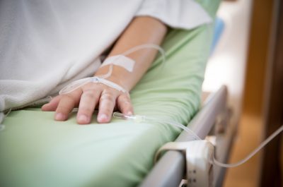 Focus patient’s hand has get the saline solution syringe on it. Illness and treatment. Health insurance plan. Focus patient’s hand has get the saline solution syringe on it. Illness and treatment. Health insurance plan.